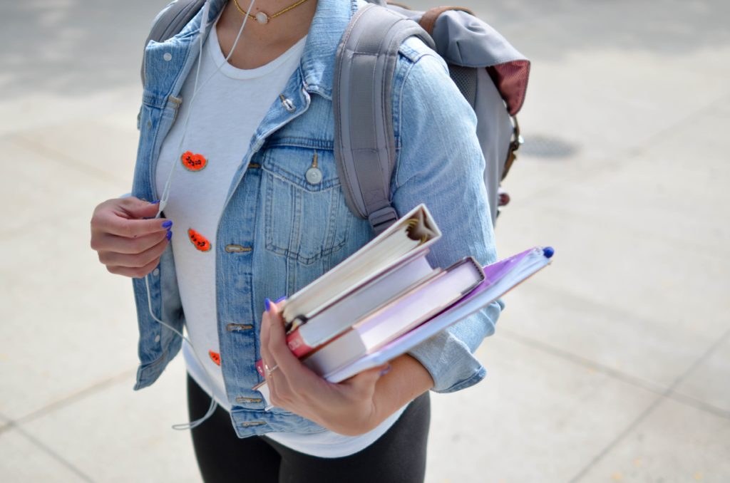 Student holding books and notebooks