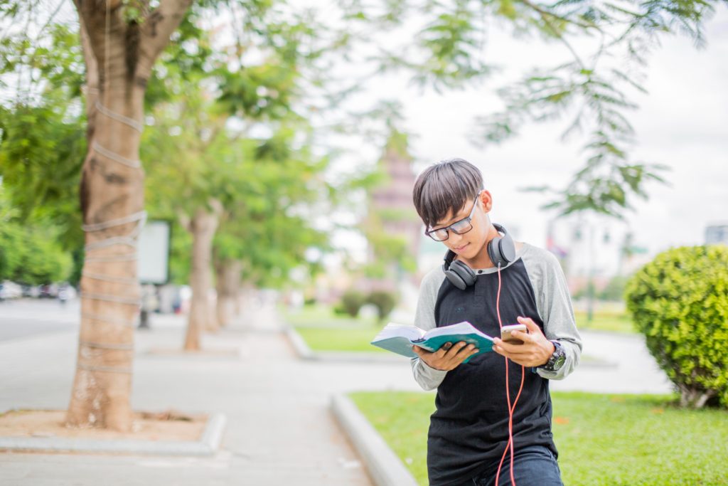 student standing with book