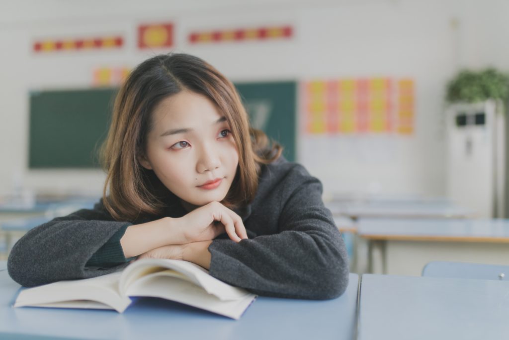 Young woman studying with book